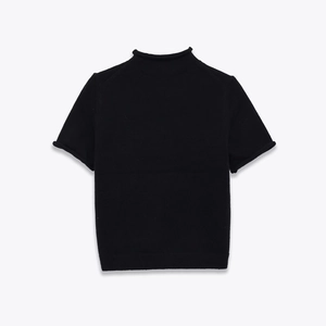 Detail shot of black mock neck knit sweater showing high-quality fine rib texture and rolled edges