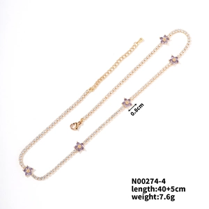 Detailed view of gold chain necklace with purple zircon flowers and full diamond accents