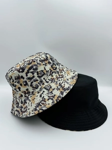 Detail showing reversible leopard print bucket hat and classic black cotton fabric sun hat