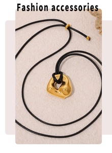 Detailed view of irregular gold heart pendant on adjustable black cord necklace