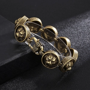 Detailed view of vintage gold plated lion head links on a men's stainless steel bracelet