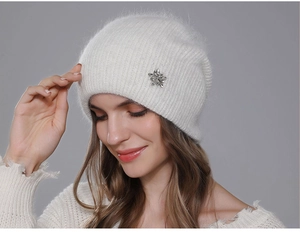 Detailed texture of white angora rabbit hair beanie with star-shaped crystal brooch