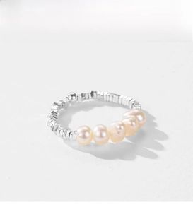 Close-up of S925 silver ring with five cream freshwater pearls and hammered texture