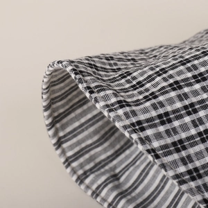 Detailed close-up of high-quality black and white checkered fabric with dense texture