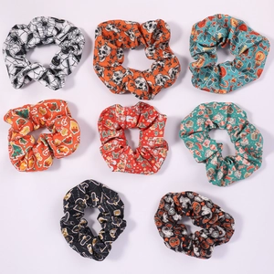 Set of 8 festive holiday scrunchies featuring Halloween and Christmas patterns on white background