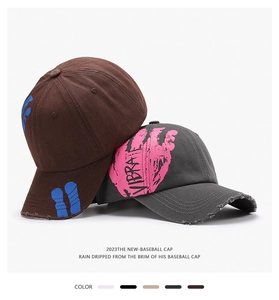 Close-up of distressed vintage cotton baseball caps with VIBRATE graphic print details