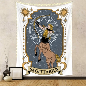 Detail of Sagittarius zodiac tapestry with moon and star symbols in a cozy home setting