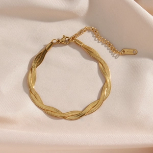 Polished K18 gold double-layered twisted snake chain bracelet on beige satin