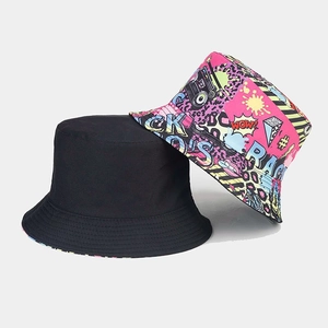 Reversible bucket hat with vintage black side and colorful graffiti print for sun protection
