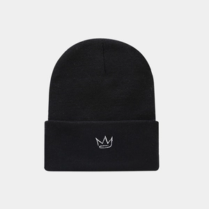 Close-up of the white crown embroidery on the textured black knitted beanie hat