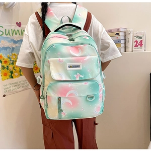 Detail of trendy gradient school backpack with moon star prints and fashion badge
