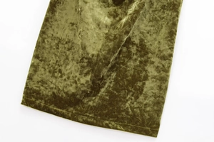 Detailed macro view of olive green velvet fabric texture showing soft luster and luxury feel