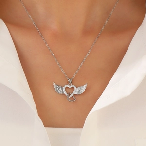 Detail of angel wing heart pendant necklace with diamonds on a model's neck