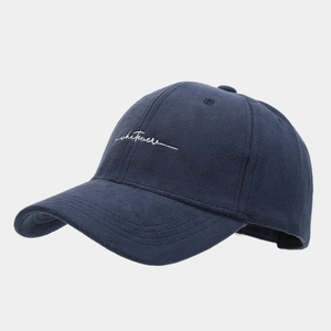 Close-up of high-quality white whatever embroidery on navy blue faux suede baseball cap