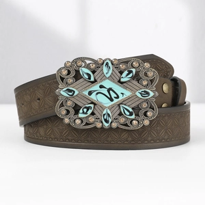 Detail of western men's brown carved leather belt with ornate turquoise eagle buckle
