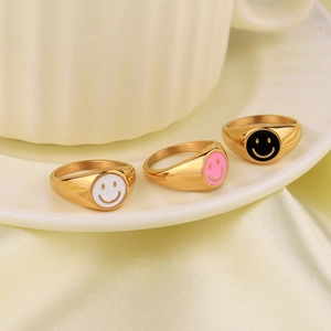Three-piece gold-tone smiley face rings set with white, pink, and black enamel designs