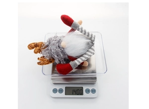 Detailed view of Rudolph gnome plush on scale showing its weight of 140 grams