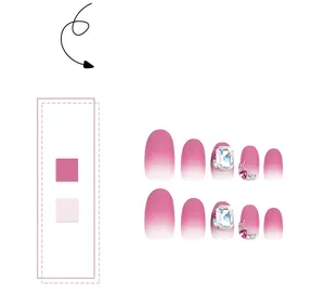 Close-up of pink gradient press-on nails featuring sparkling crystal rhinestones and hearts