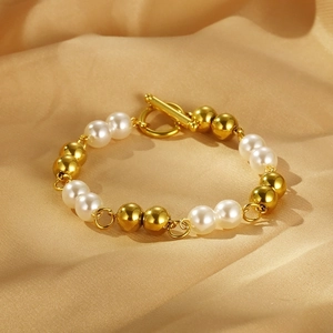 Detail of gold beads and white pearls bracelet with a vintage OT toggle clasp