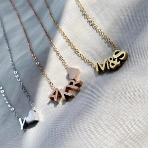 Custom stainless steel letter necklaces in silver, rose gold and gold with small heart charms