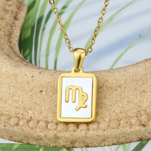 Macro shot of gold Virgo constellation square pendant with white shell inlay and chain