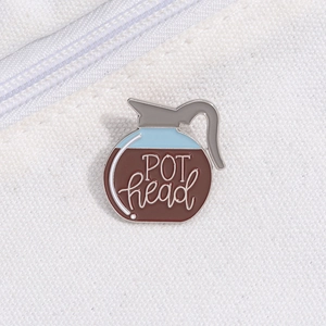 Detailed view of coffee pot enamel pin with POT head text on white canvas bag