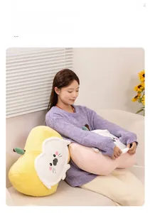 Detail of soft plush seal fruit pillow with cute facial embroidery on home sofa
