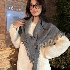 Deep grey knitted triangle scarf with tassels and leather logo tag for winter