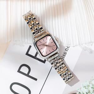 Detailed close-up of a silver stainless steel watch with a pink square sunray dial