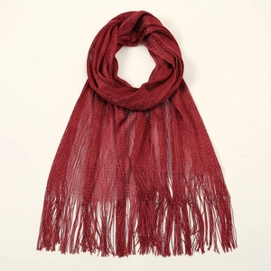 Close-up of dark red metallic thread weave and long tassel fringe on summer shawl
