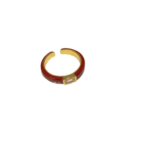 Elegant gold-plated open ring with red enamel and rectangular zircon on white backdrop