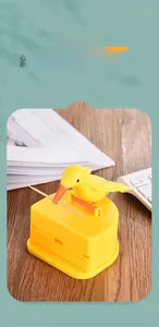 Detail of bird-shaped automatic toothpick dispenser showing smooth yellow plastic finish
