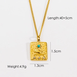 Detail view of a gold pendant with a sun and palm totem showing 40+5cm chain length