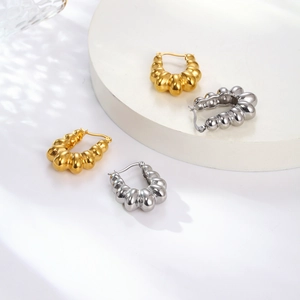 Vintage geometric C-shaped ribbed earrings in polished gold and silver stainless steel
