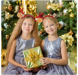 Close-up of red reindeer antlers headband with brown ears and golden bells for Christmas