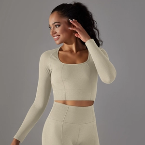 Detailed view of beige seamless honeycomb texture on knit yoga long sleeve crop top