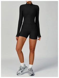 Detailed view of women's black ribbed yoga set featuring a zip-up jacket and high-waist shorts
