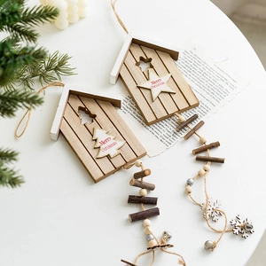 Nordic wooden Christmas house wind chime with bells and snowflakes on a white background