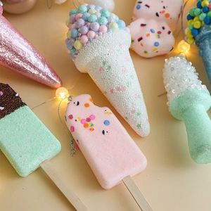 Pastel Christmas ice cream ornaments with glitter on warm background for tree decor