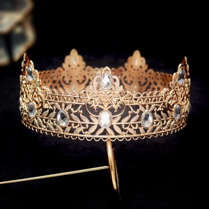 Detailed macro view of the golden baroque crown with intricate hollow carvings and crystals