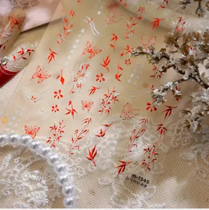 Macro view of M1345 nail art stickers featuring red bamboo and silver flower motifs
