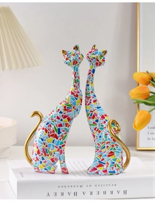 Artistic cat sculptures with mosaic patterns and golden details for home decor display