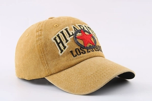 Detail of washed yellow baseball cap with vintage embroidery and star emblem