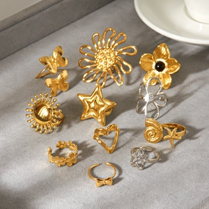 Assorted gold and silver stainless steel rings with flower, heart, and star designs