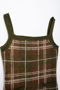 Detail of green and brown plaid knitted camisole top with textured fabric surface