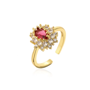 Adjustable gold plated ring with oval red gemstone and white zircon accents on white background