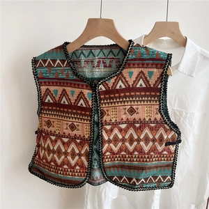 Detailed view of ethnic embroidery patterns and woven geometric motifs on the vest shawl