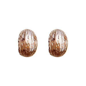 Golden geometric C-shaped hoop earrings with unique organic hammered metal texture
