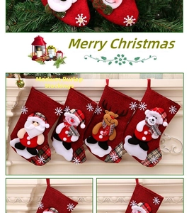 Detail of four burlap Christmas stockings with Santa and snowman hanging on a fireplace
