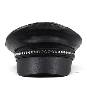 Close-up of black PU leather military cap with silver metal studs and detailed stitching